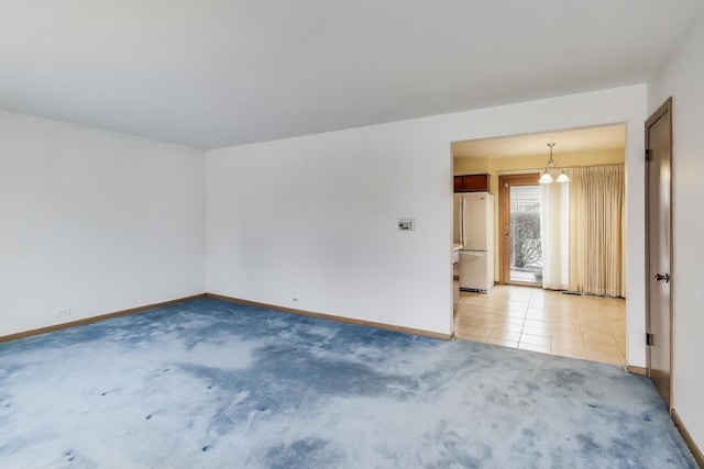 unfurnished room featuring light colored carpet