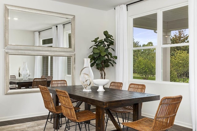 dining space with a wealth of natural light and dark hardwood / wood-style floors