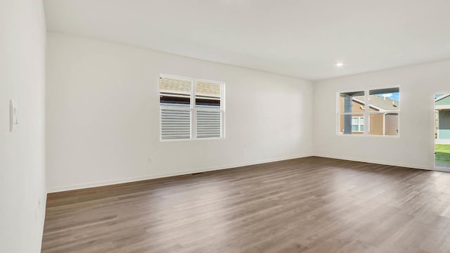 spare room with dark hardwood / wood-style floors