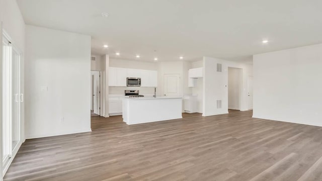 unfurnished living room with light wood-type flooring