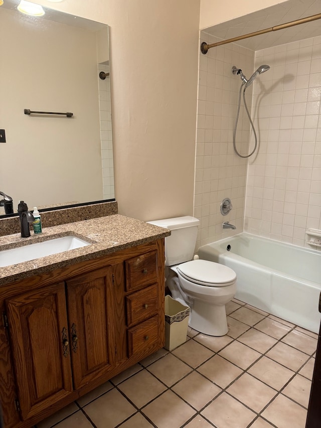 full bathroom with vanity, tiled shower / bath combo, tile patterned floors, and toilet