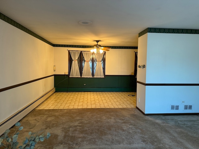 unfurnished room with ceiling fan, light colored carpet, and baseboard heating