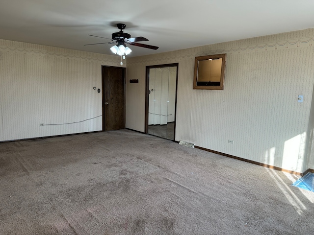 spare room featuring carpet floors and ceiling fan