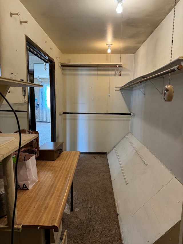 kitchen with dark colored carpet and white cabinetry