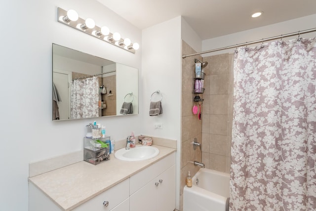 bathroom featuring vanity and shower / bath combination with curtain