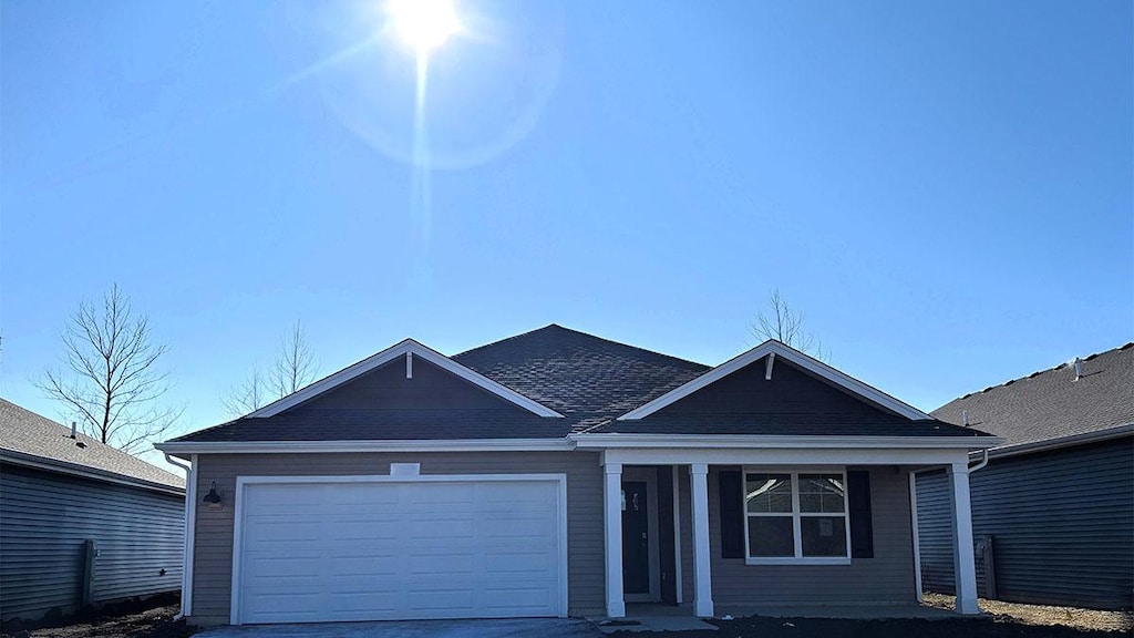 ranch-style home with a garage and driveway