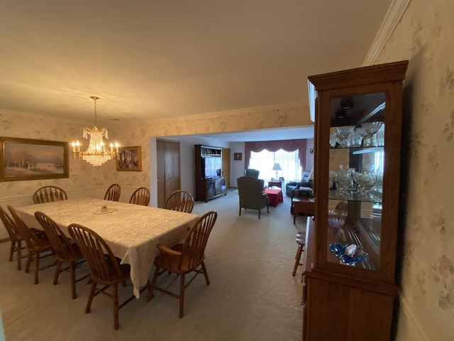 dining space with carpet floors, ornamental molding, and wallpapered walls