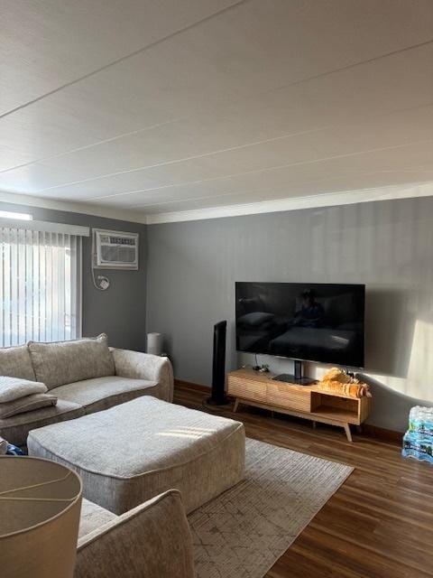 living room with hardwood / wood-style floors and an AC wall unit