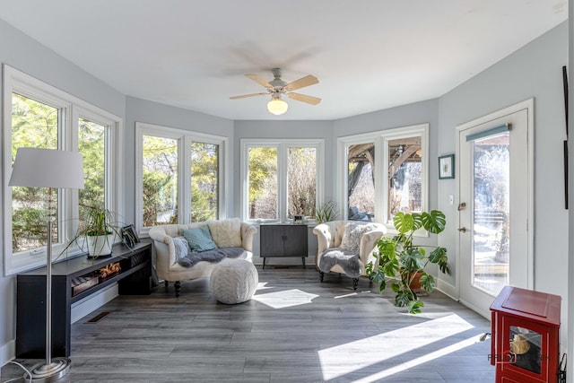 sunroom featuring visible vents, plenty of natural light, and ceiling fan