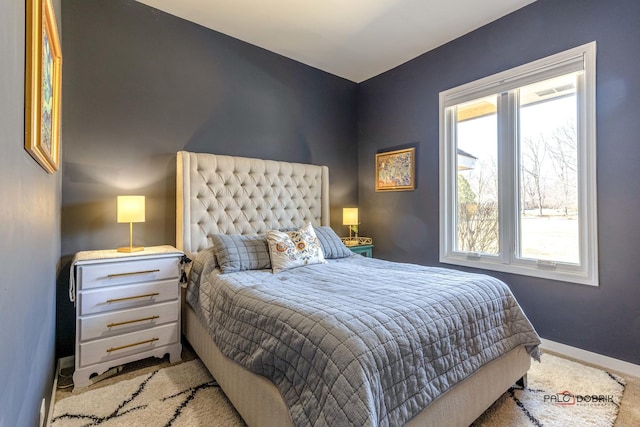 carpeted bedroom featuring baseboards