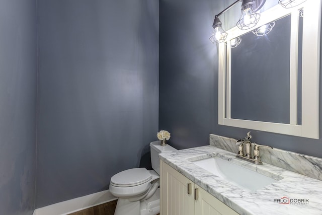 half bathroom featuring toilet and vanity