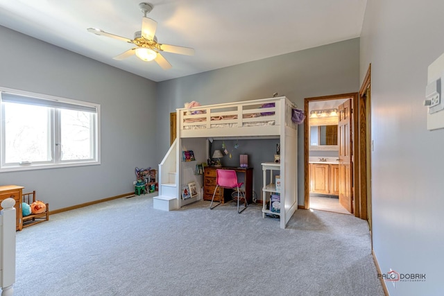 bedroom featuring a ceiling fan, a sink, ensuite bath, carpet floors, and baseboards