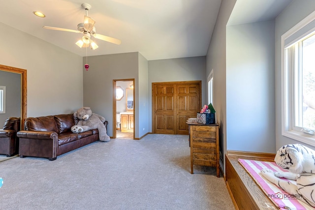 living area featuring ceiling fan and carpet flooring