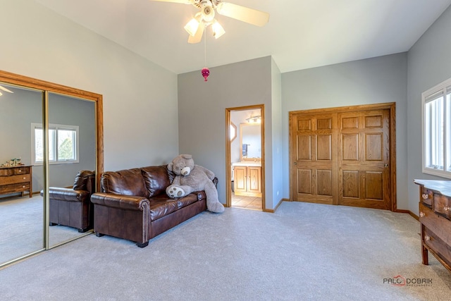 carpeted living room featuring baseboards and ceiling fan