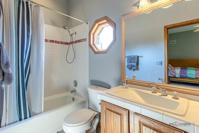 bathroom featuring toilet, shower / bath combo, and vanity