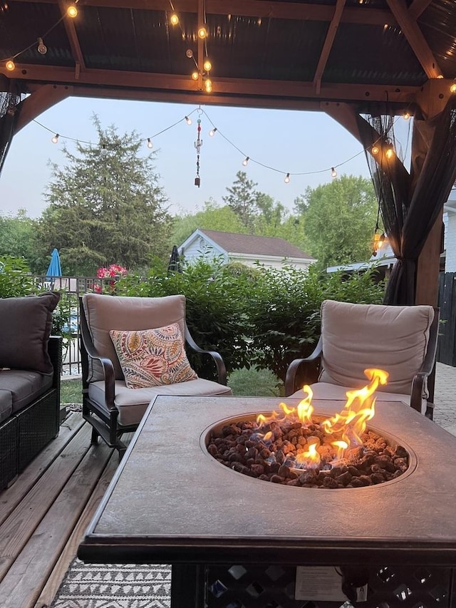 view of patio / terrace featuring a wooden deck and a fire pit