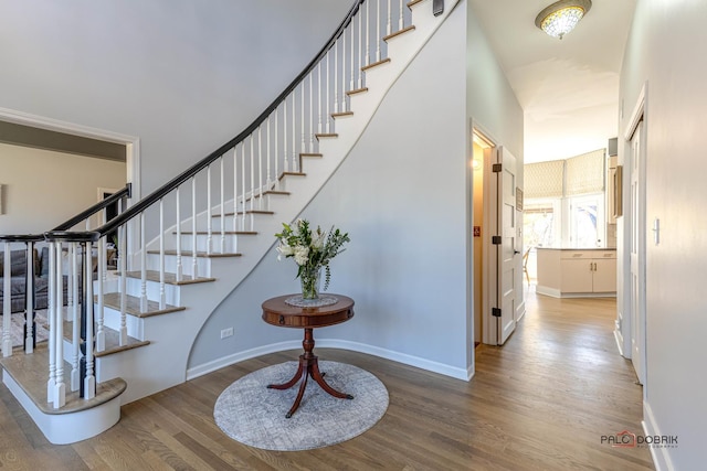 stairs with baseboards and wood finished floors