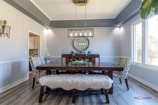 dining space with wood finished floors and baseboards