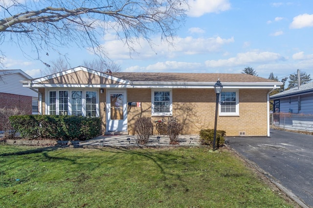 single story home with a front yard, driveway, a shingled roof, crawl space, and brick siding