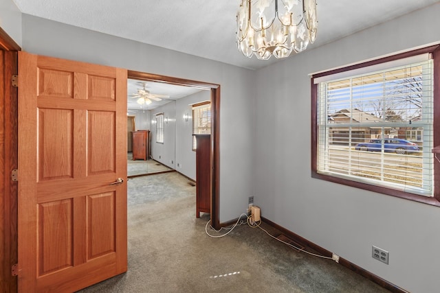 dining space featuring baseboards, a chandelier, and carpet flooring