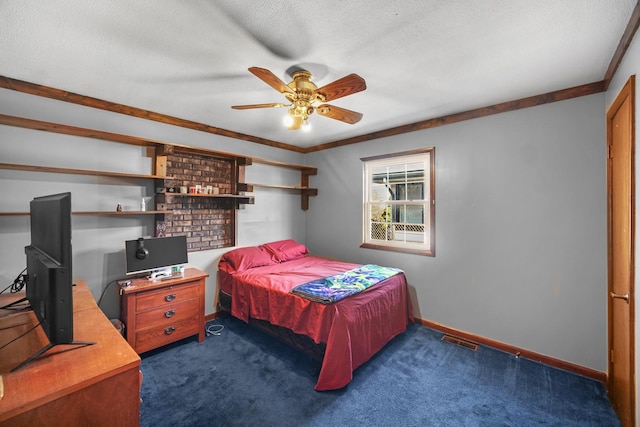 carpeted bedroom with visible vents, a textured ceiling, crown molding, baseboards, and ceiling fan