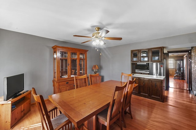 dining room featuring a ceiling fan and light wood-style floors