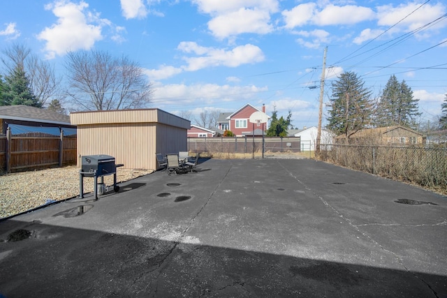 exterior space with a storage unit and a fenced backyard