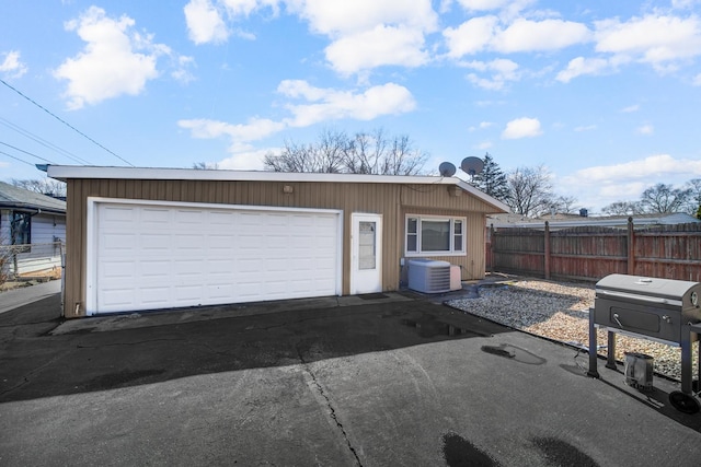 garage with cooling unit and fence