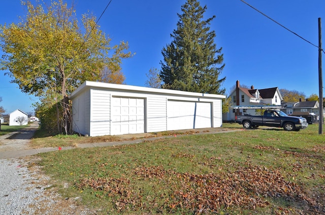 garage featuring a lawn