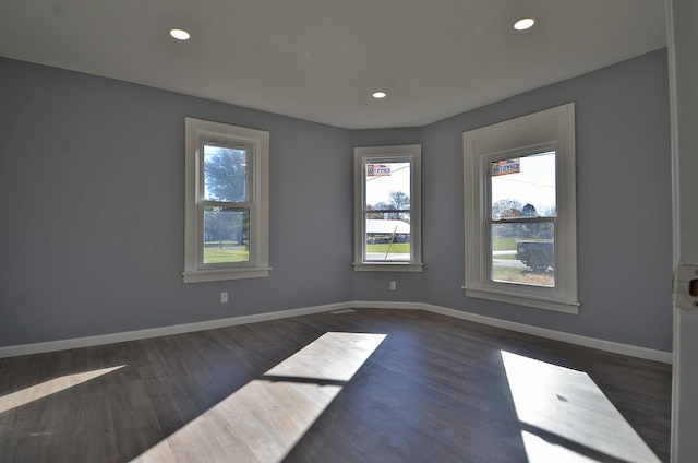 empty room featuring dark wood-type flooring