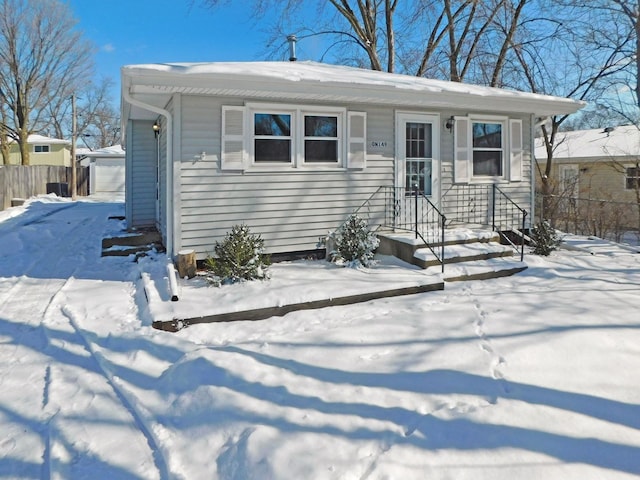 view of front facade with a garage and an outbuilding