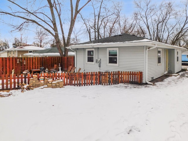 view of snow covered rear of property