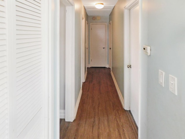 hallway with dark hardwood / wood-style flooring