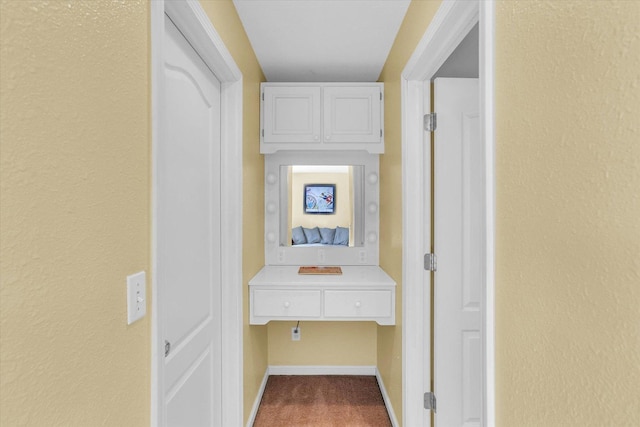 corridor featuring carpet and baseboards