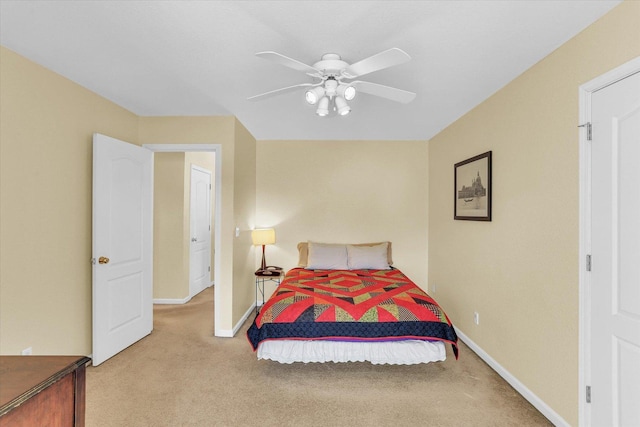 bedroom with baseboards, a ceiling fan, and light colored carpet