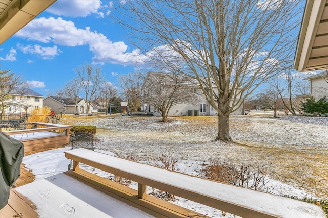 yard layered in snow with a residential view