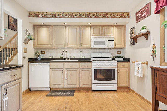 kitchen featuring tasteful backsplash, sink, white appliances, and light hardwood / wood-style flooring