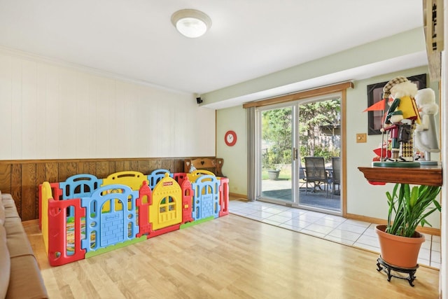 recreation room featuring crown molding and hardwood / wood-style flooring