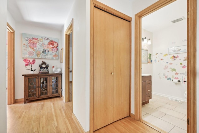 hallway with light hardwood / wood-style floors