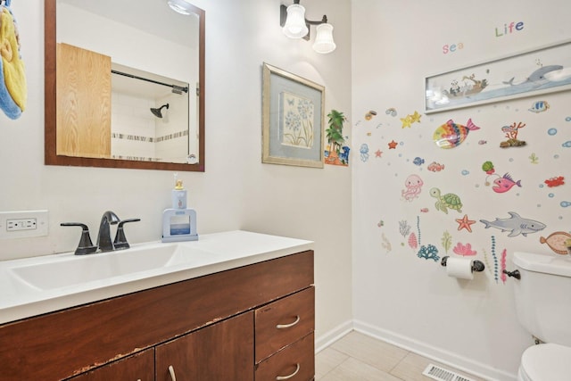 bathroom with vanity, toilet, and a shower