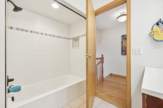 bathroom with tile patterned floors, tiled shower / bath combo, and vanity