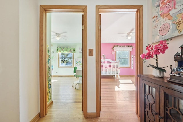 entryway with light hardwood / wood-style flooring, a wealth of natural light, and ceiling fan