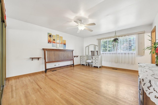 living area featuring hardwood / wood-style flooring and ceiling fan