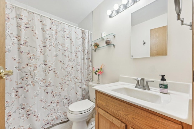 bathroom featuring a shower with curtain, vanity, and toilet