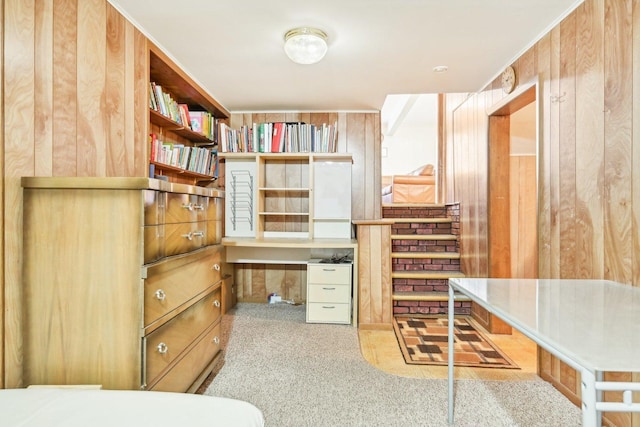 interior space featuring built in desk and wooden walls