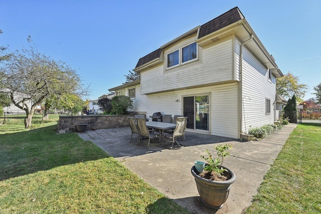 back of property with a lawn and a patio