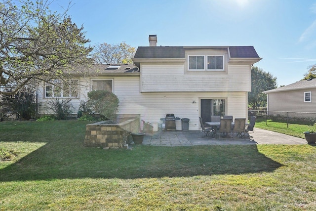 back of property featuring a patio and a yard