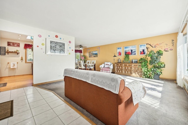 living room featuring ceiling fan and light tile patterned floors