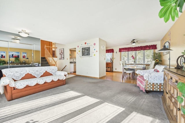 carpeted living room with ceiling fan