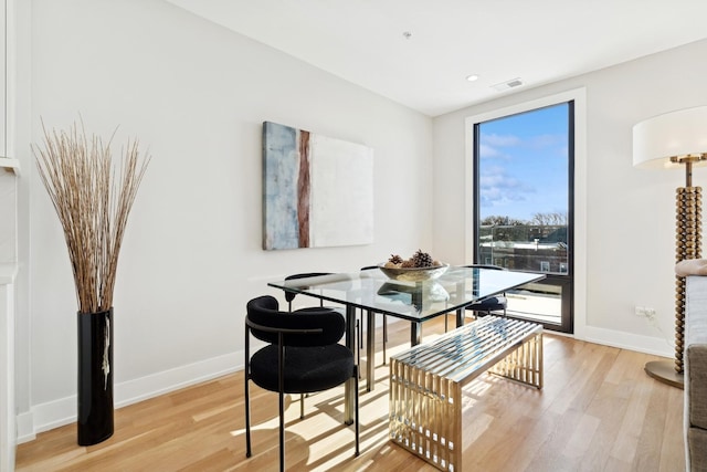 dining space with light hardwood / wood-style flooring